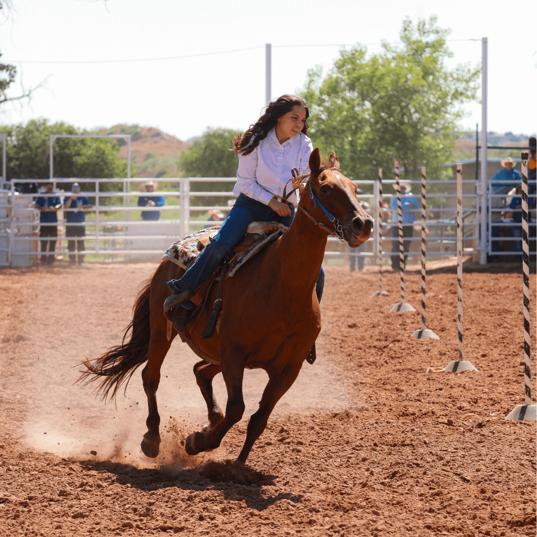 Picture of Nevaeh participating in pole bending at the Boys Ranch Rodeo